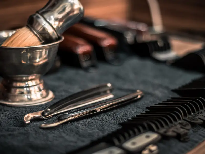 Barber’s shaving brush, razor and combs on a counter