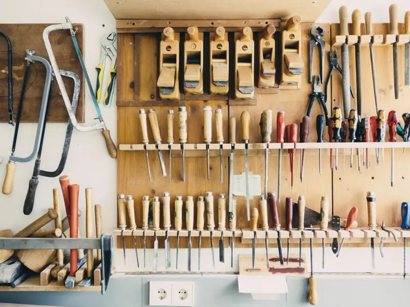 Hand tools hanging on a workshop wall