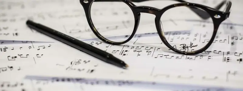 Black-rimmed glasses on sheet music